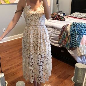 Showpo White lace dress with tan slip underneath.